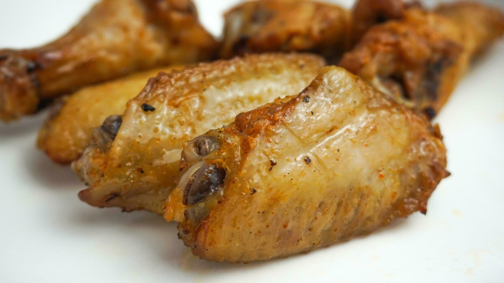 chicken wings and thighs that have been fried until browned, delicious photo