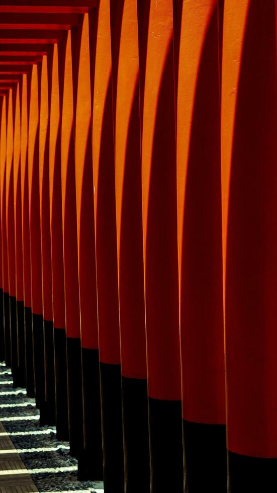 Ornaments on the Sam Poo Kong Pagoda in Semarang, a building lined with red pillars and black lines interspersed with reflections of sunlight.no people photo