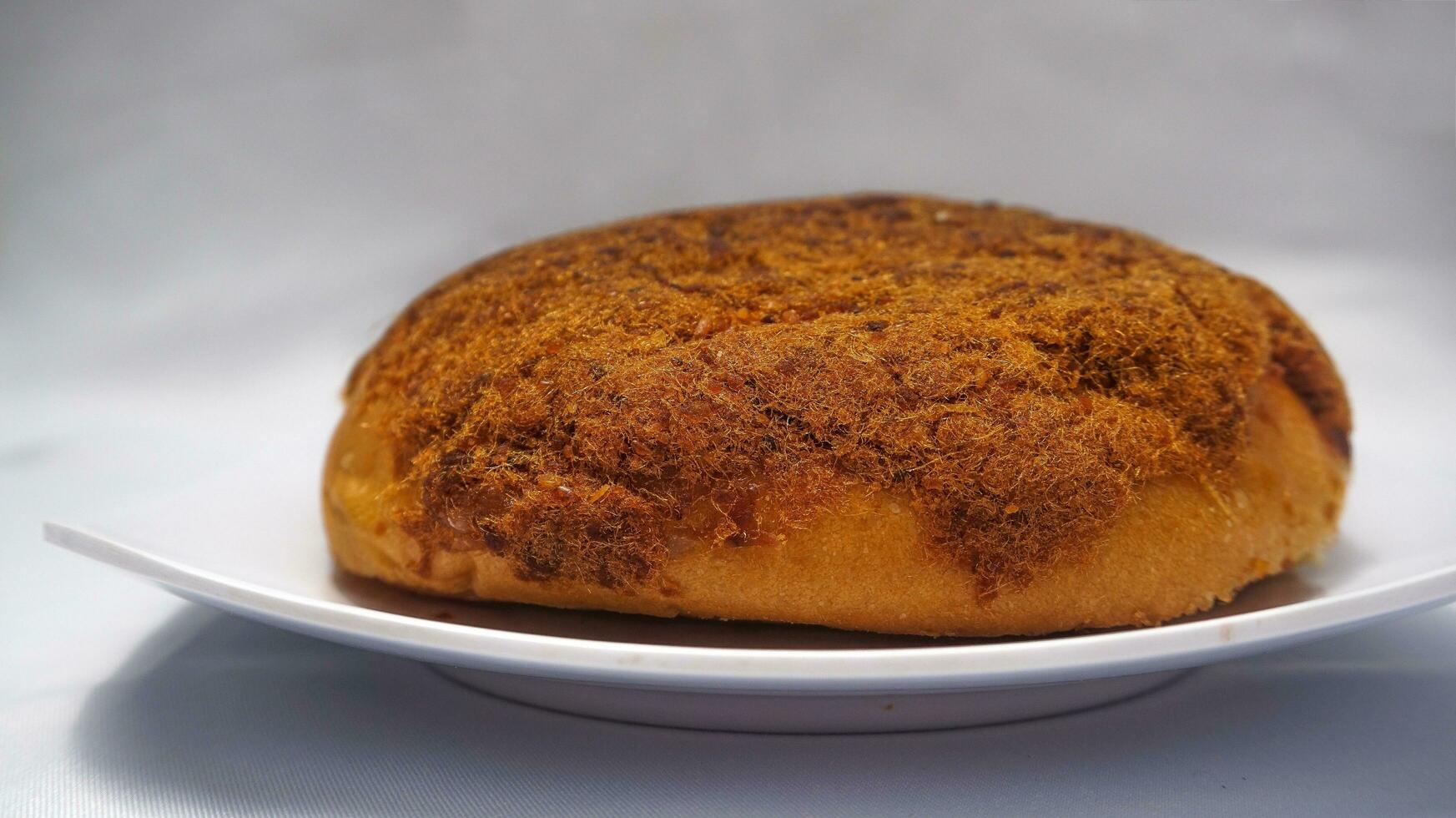 Bread topped with spicy beef floss for breakfast or snack photo