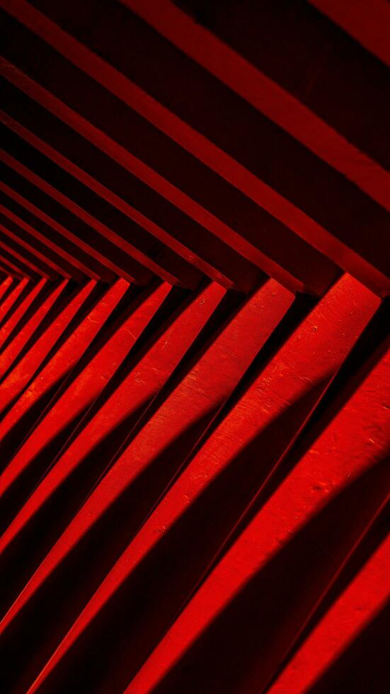 Ornaments on the Sam Poo Kong Pagoda in Semarang, a building lined with red pillars and black lines interspersed with reflections of sunlight.no people photo