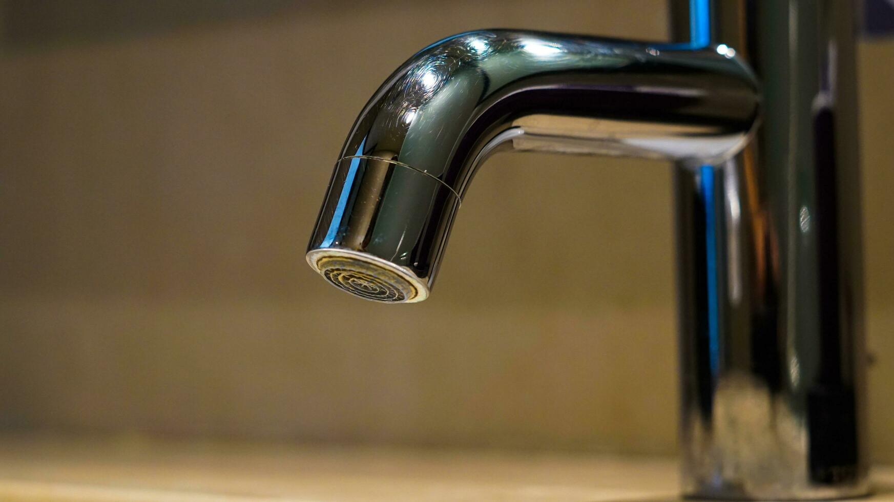 Water tap in the sink for washing hands and rinsing face photo