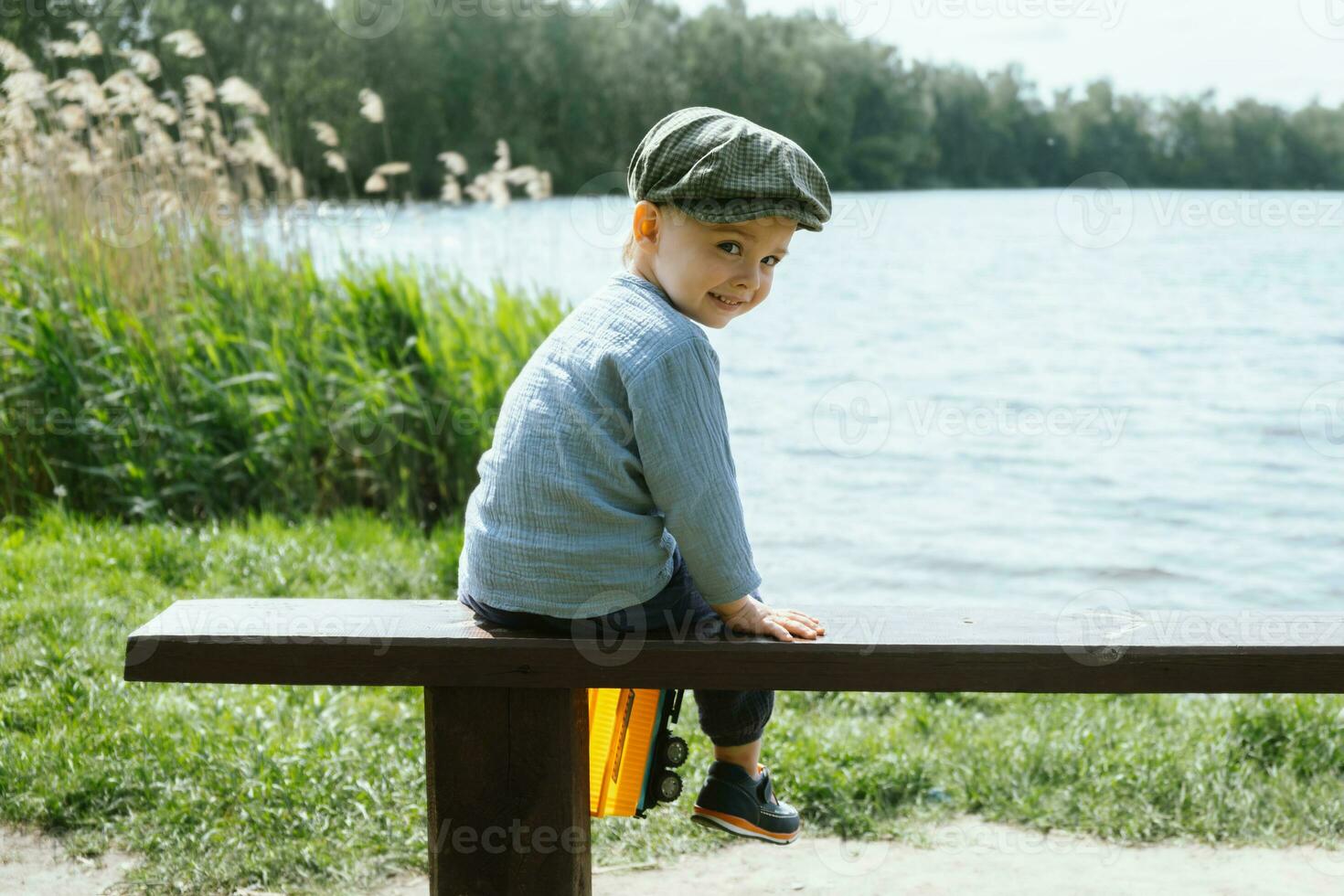 Little boy walking in countryside in summer. Children outdoor activities. photo