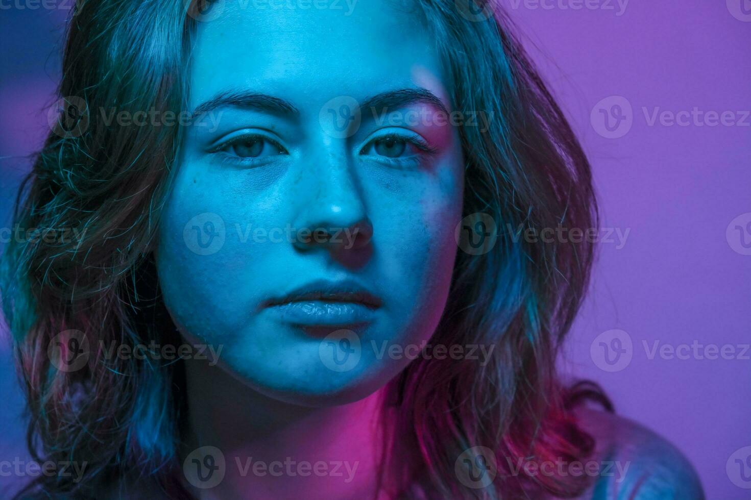 Blue and purple coloured portrait of beautiful teen girl with freckles. photo