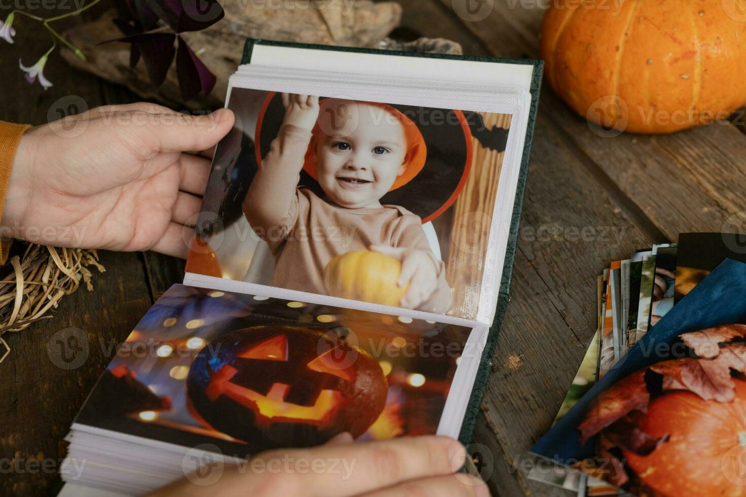 Browsing Halloween printed photos in picture album.