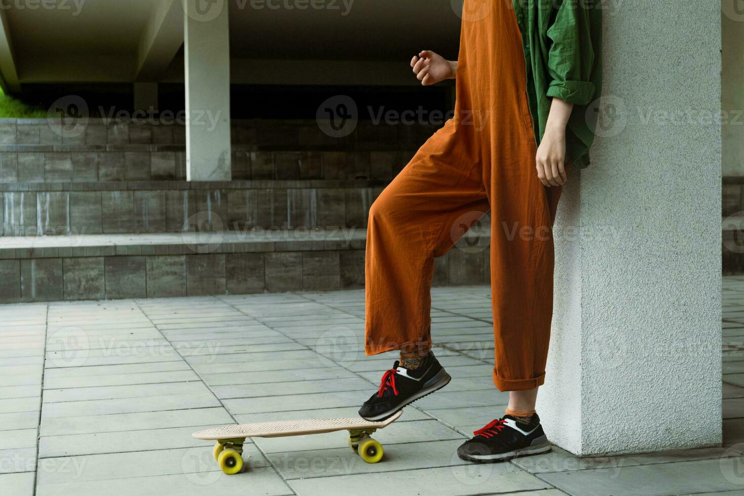 Female skateboarder legs with skateboard. photo