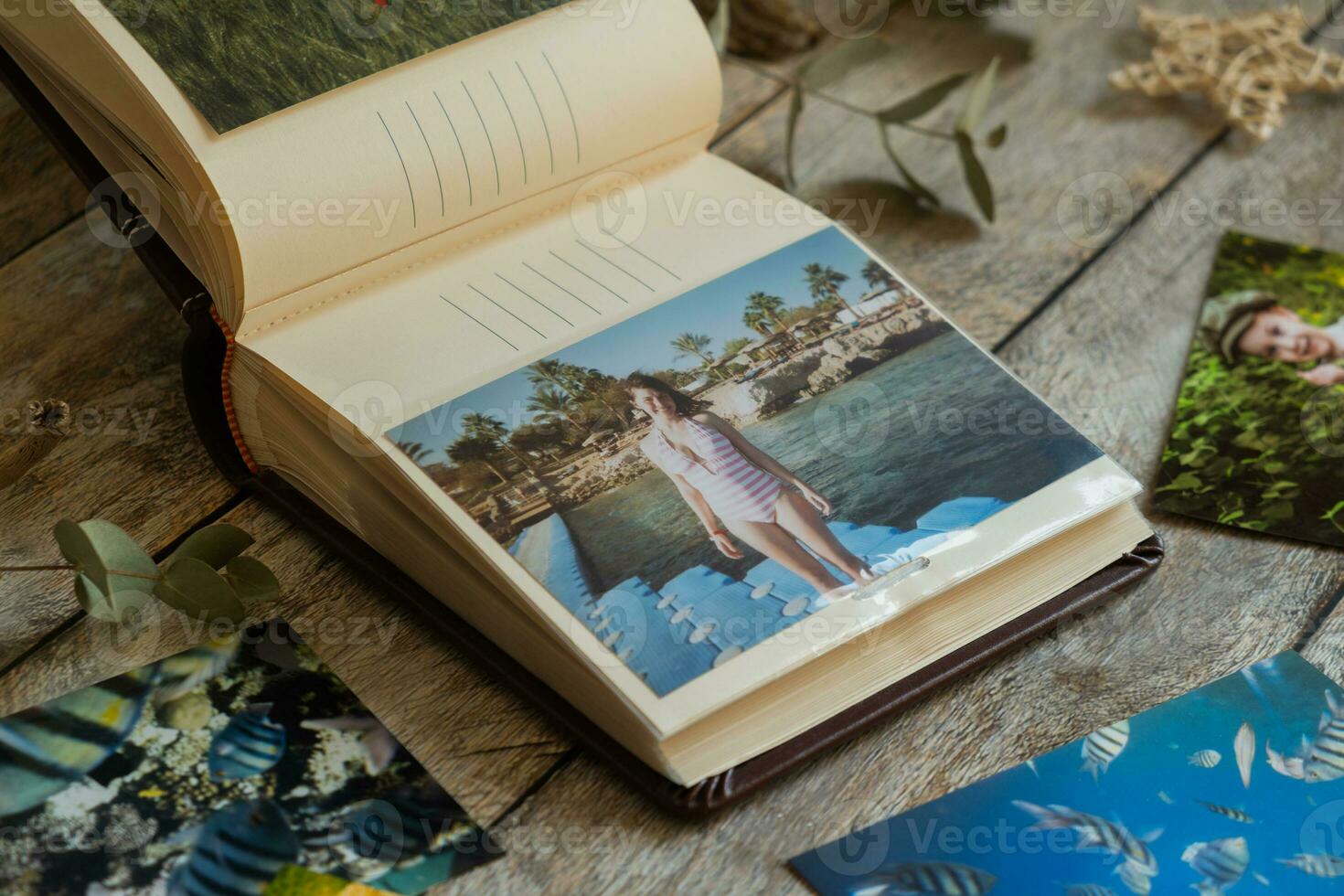 Printed photos in picture album. Summer memories.