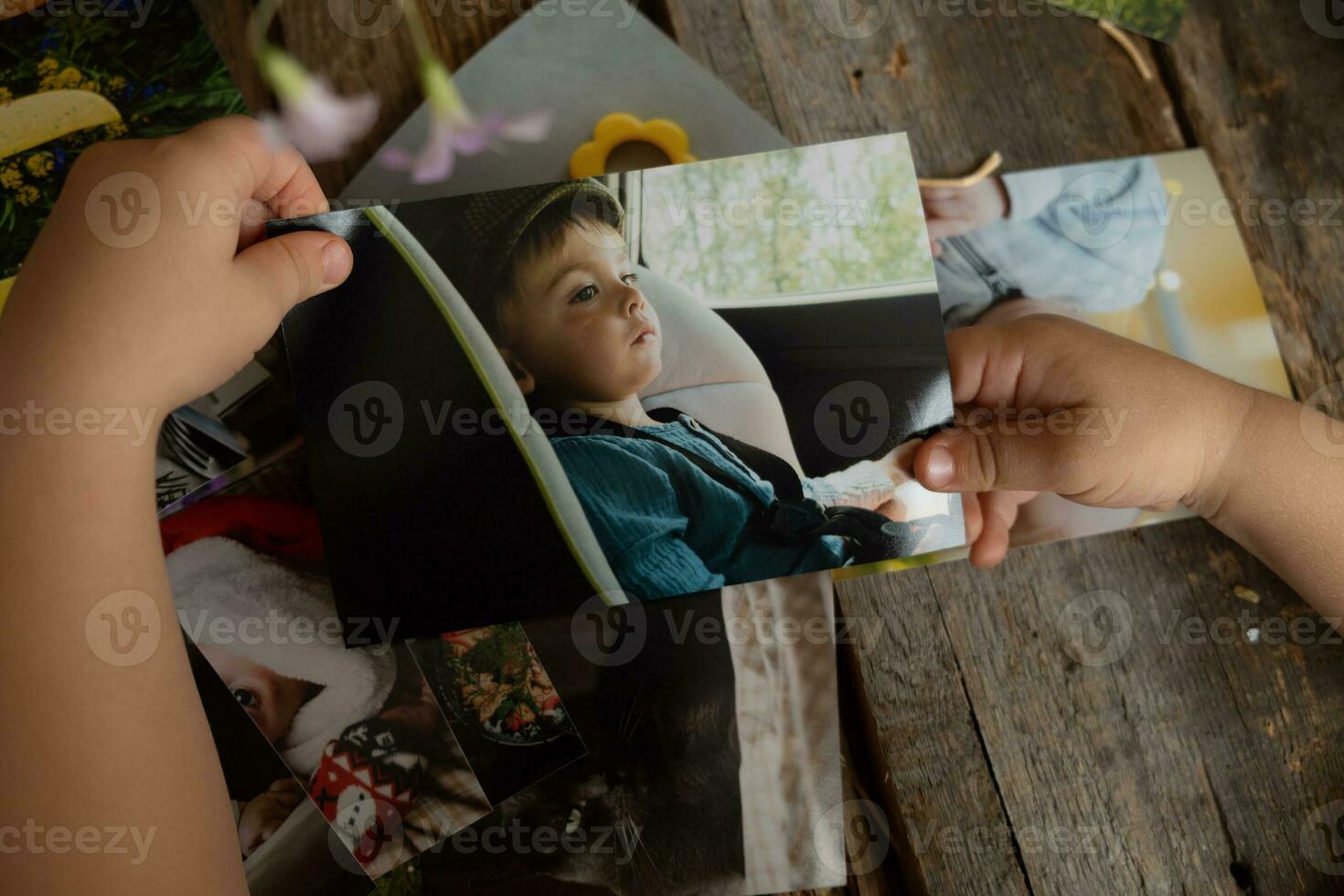 Photo printing concept. Baby hands hold printed photos.