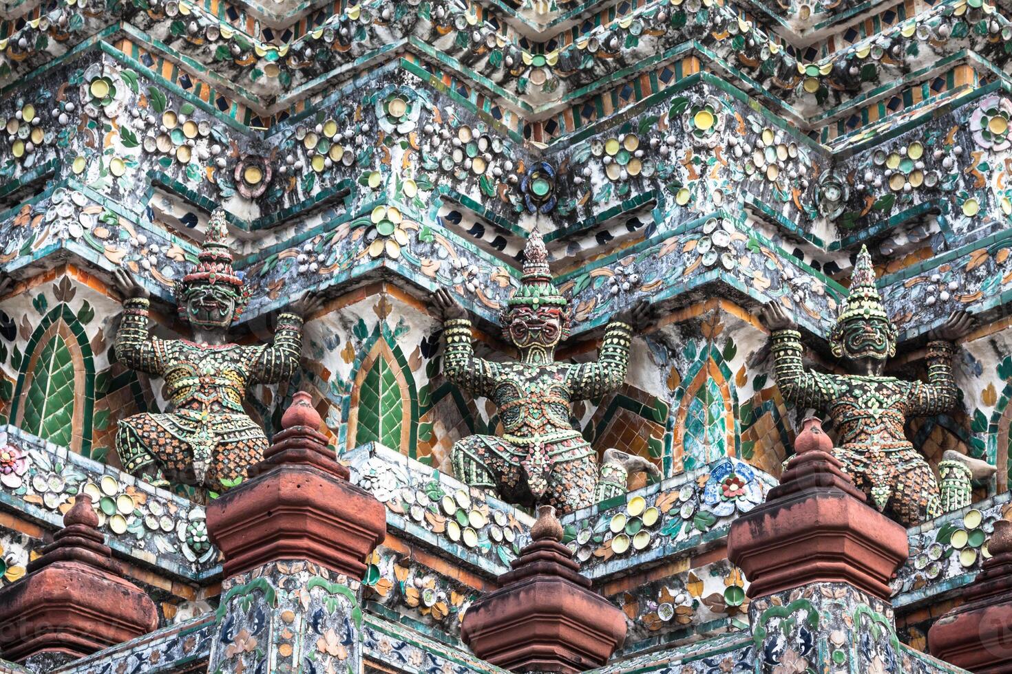 Demon Guardian statues decorating the Buddhist temple Wat Arun in Bangkok, Thailand photo