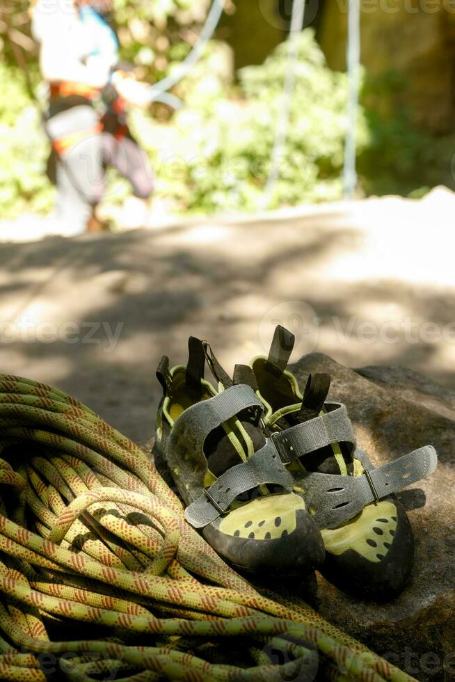 Hiking boots and rope on campfire background. Lifestyle travel relationship. photo