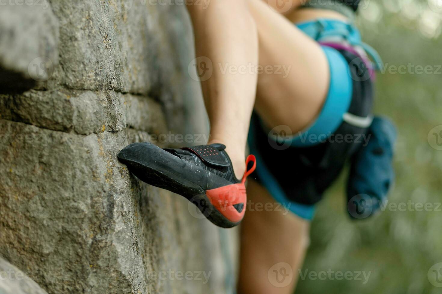 Rock climber about to start climbing his route photo