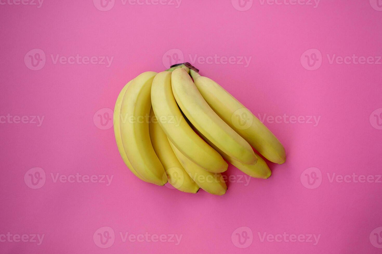 Single banana on a pink background with strong shadow photo