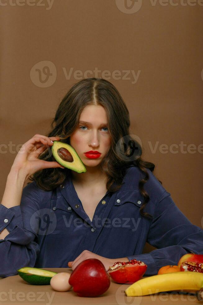 Young woman in group of fruit. Healthcare. photo