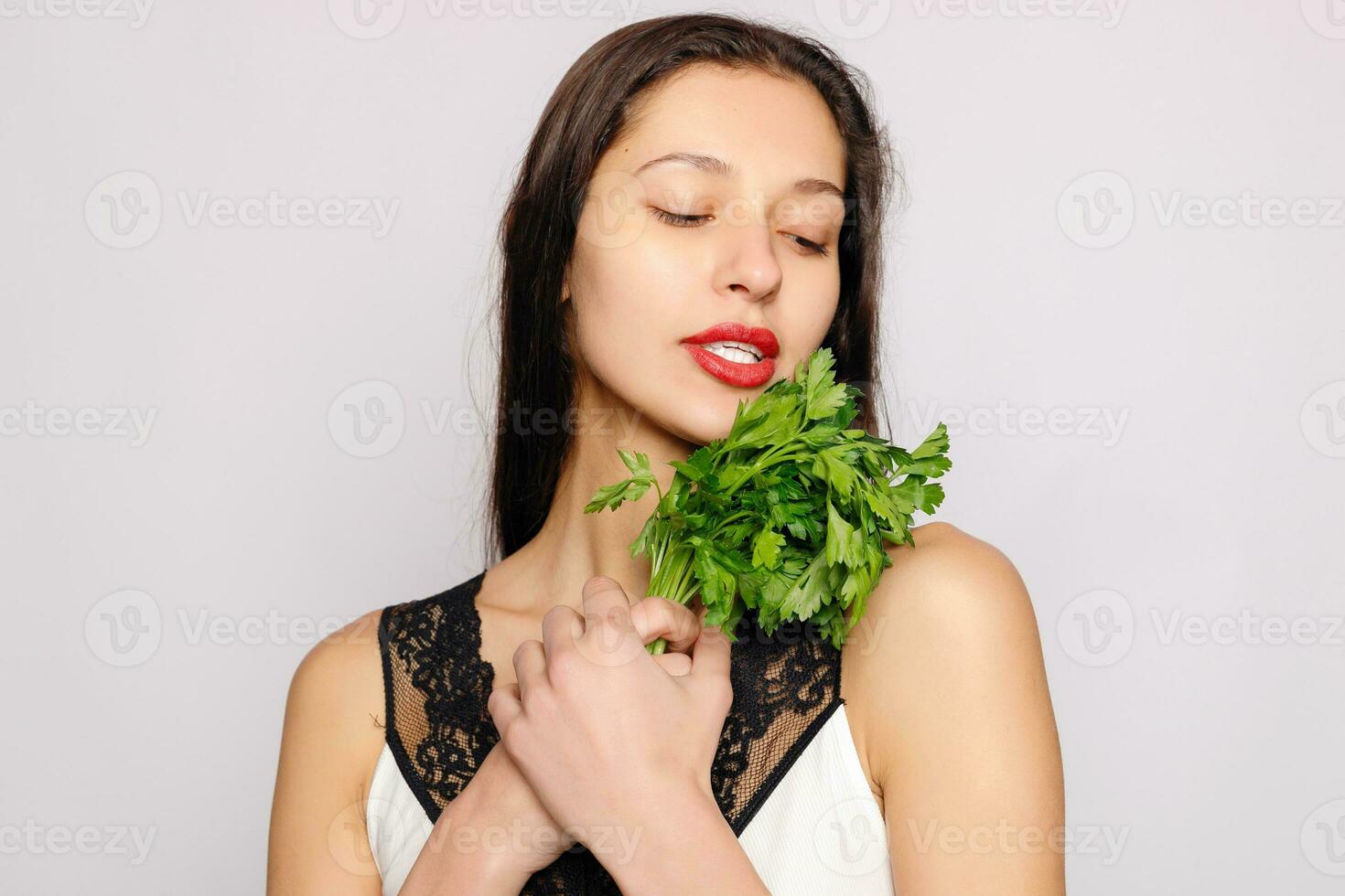 Beautiful smiling girl with parsley. Healthy lifestyle concept photo