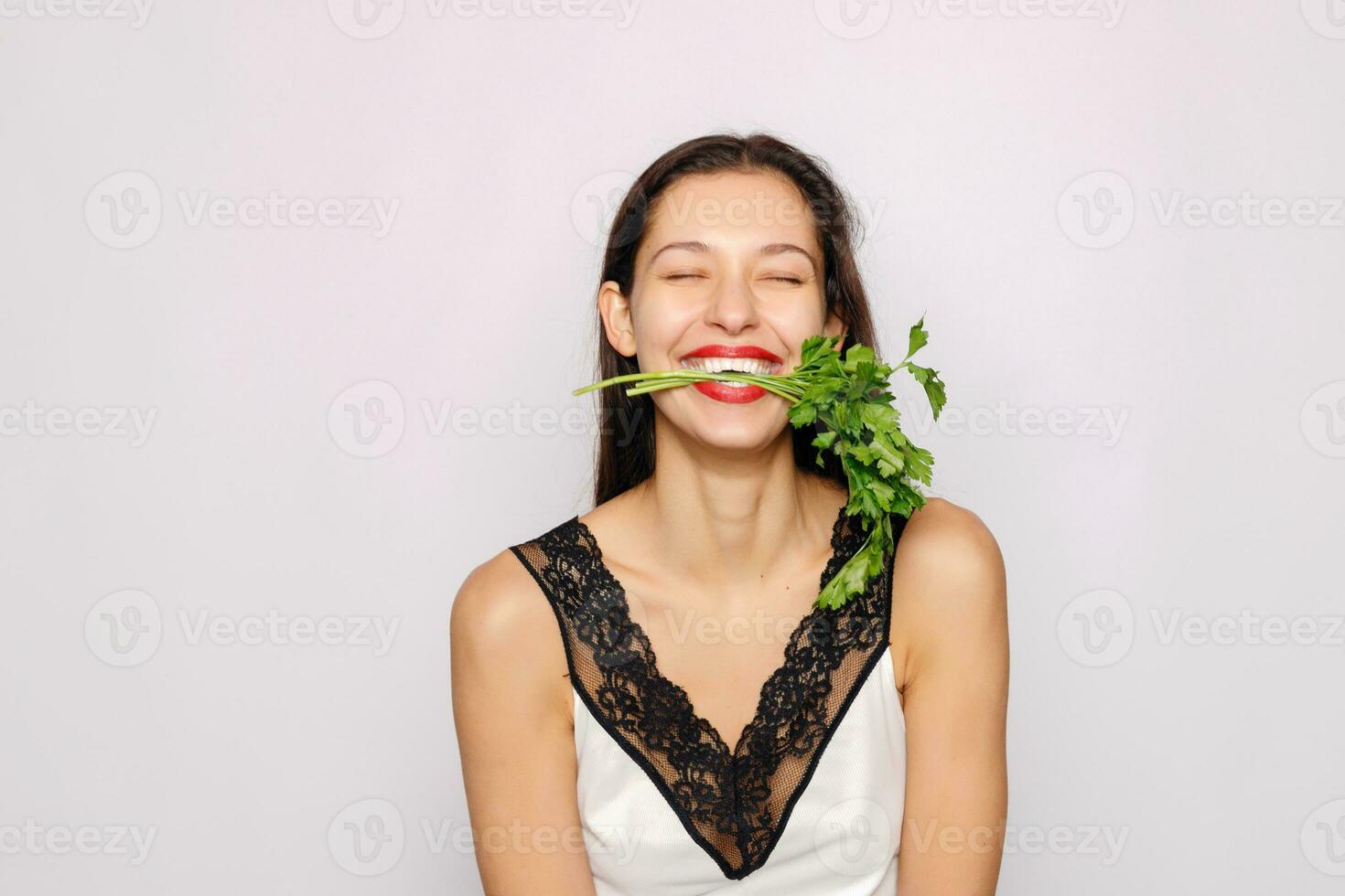 Beautiful smiling girl with parsley. Healthy lifestyle concept photo