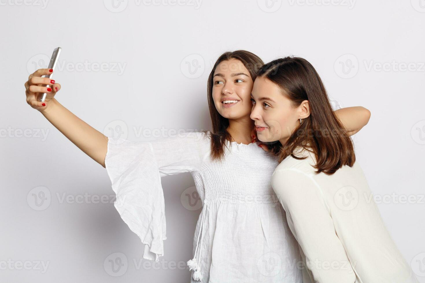 Beautiful girlfriends taking a self shot with phone. photo