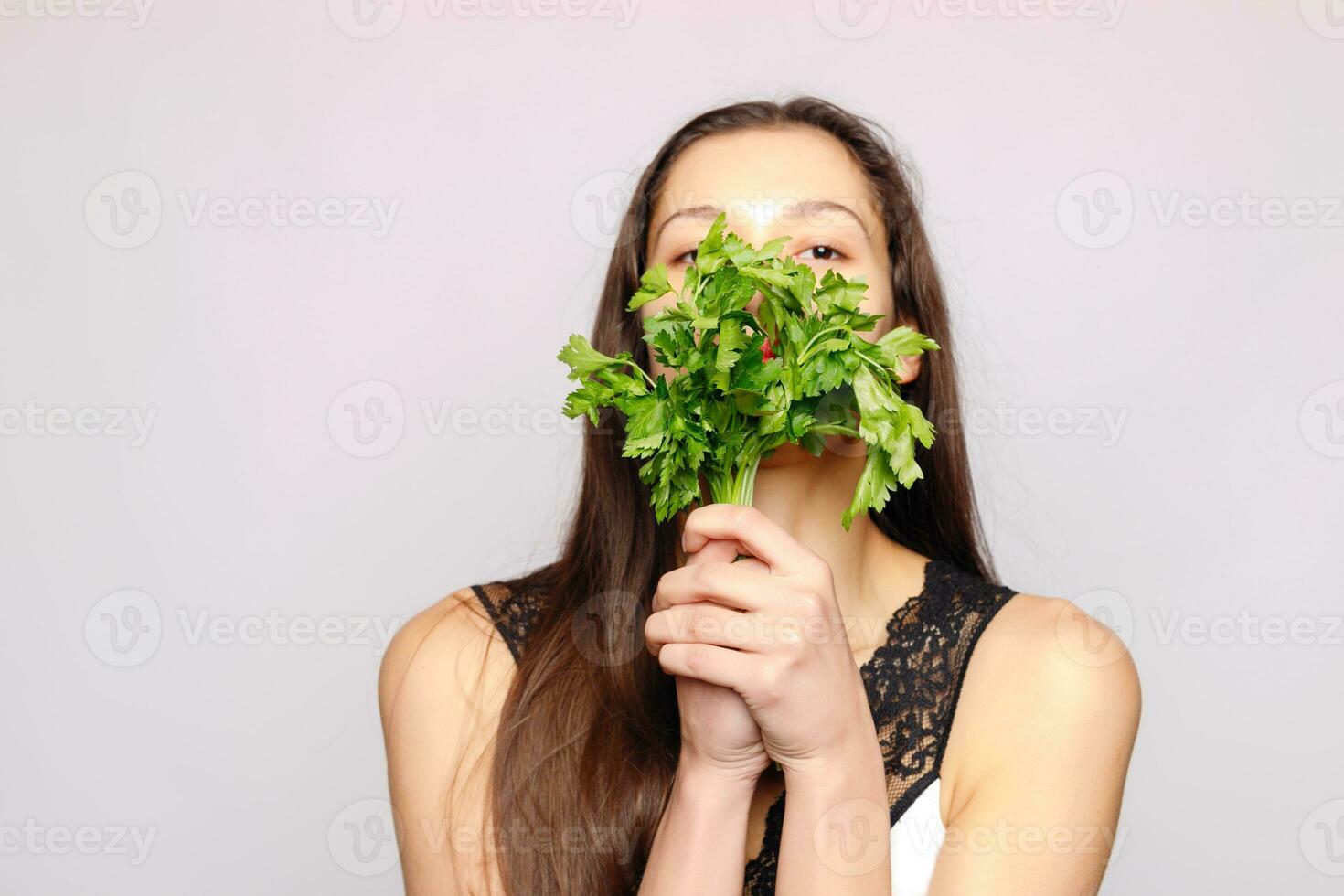 Beautiful smiling girl with parsley. Healthy lifestyle concept photo