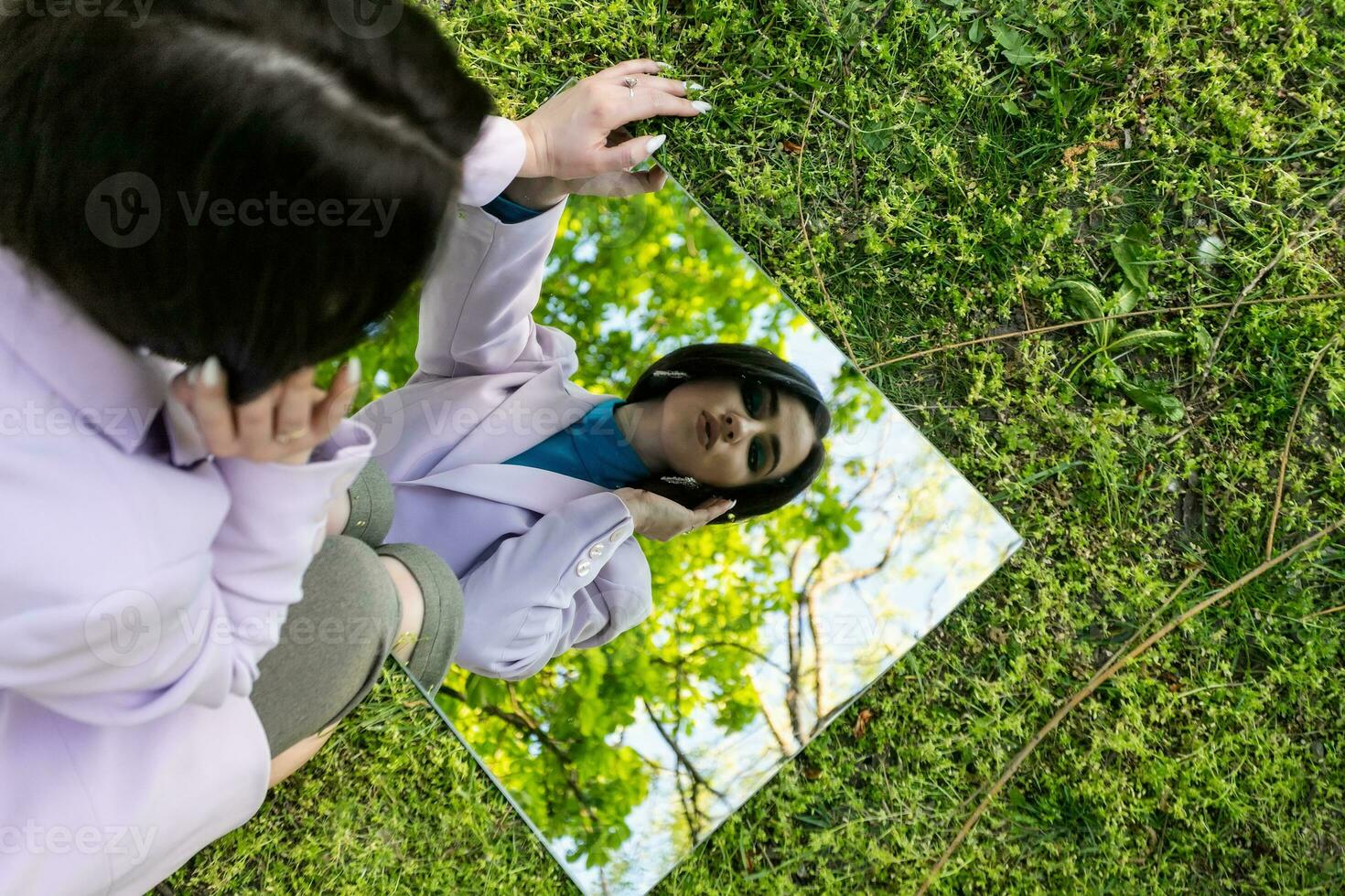 portrait in the mirror of a beautiful girl against the sky photo