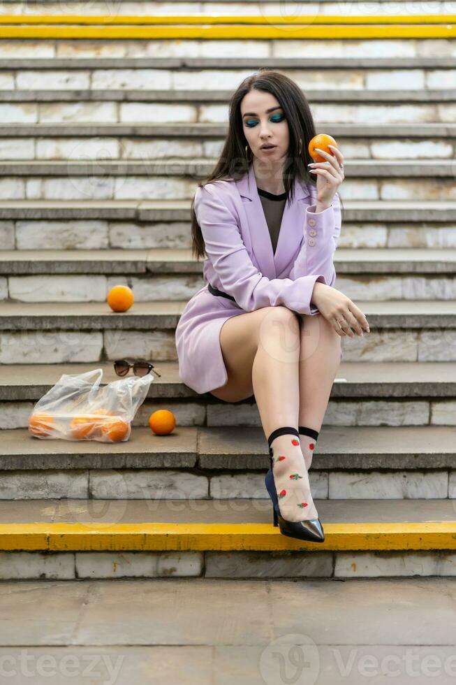 Fashion pretty woman model with fruit oranges photo