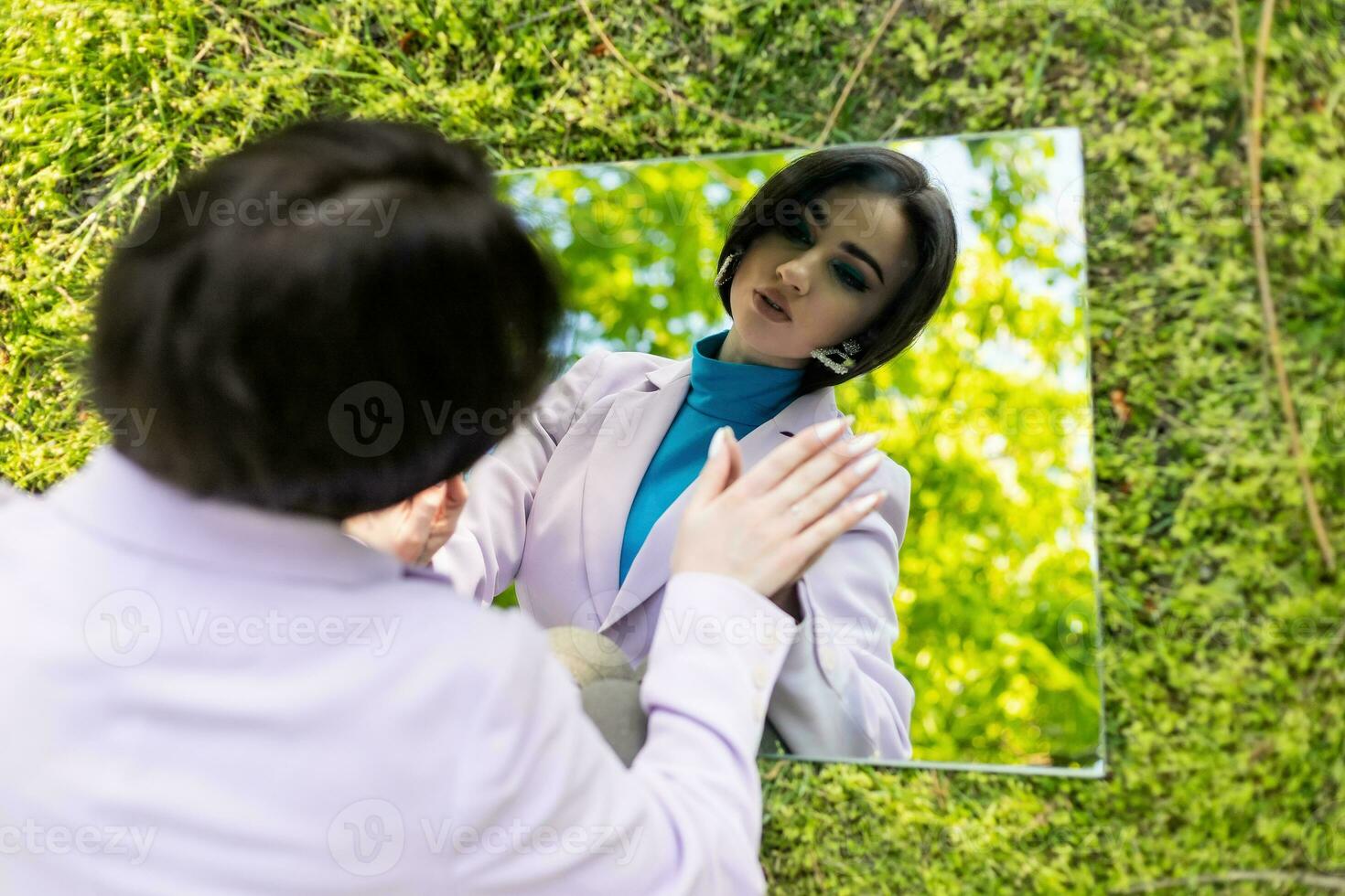 portrait in the mirror of a beautiful girl against the sky photo