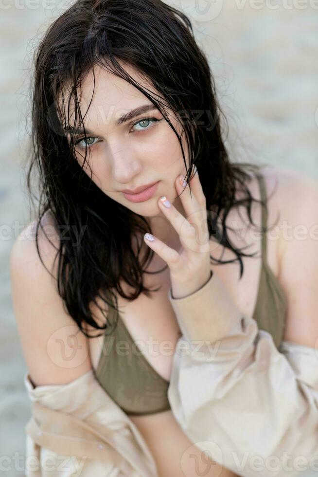 Beautiful bohemian styled and tanned girl at the beach photo