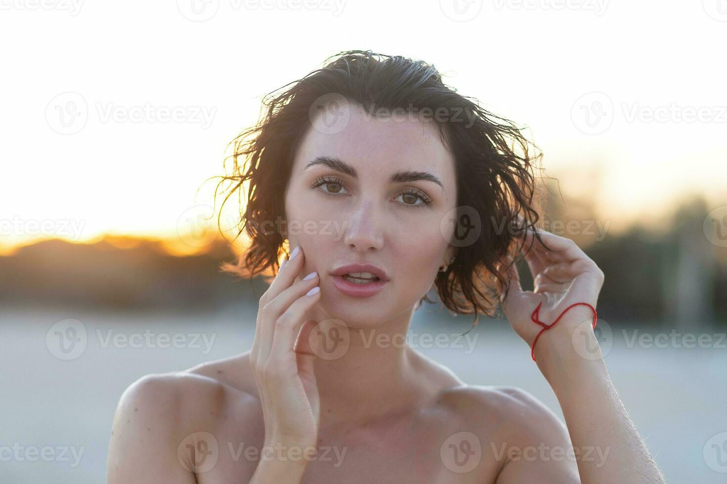 Sexy back of a beautiful woman in red bikini on sea background photo