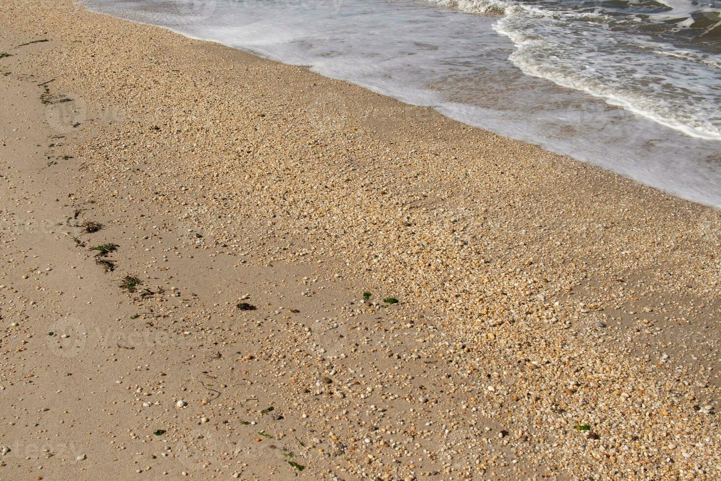 I loved the look of the ocean coming into the beach here. The sea foam slowly washing over the pretty pebbles some of which look like gems and are translucent all very smooth from being tumbled. photo