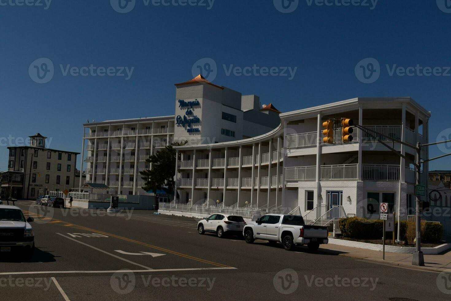 This beautiful Marquise de Lafayette hotel stands tall on the street at Cape May New Jersey with many balconies. photo