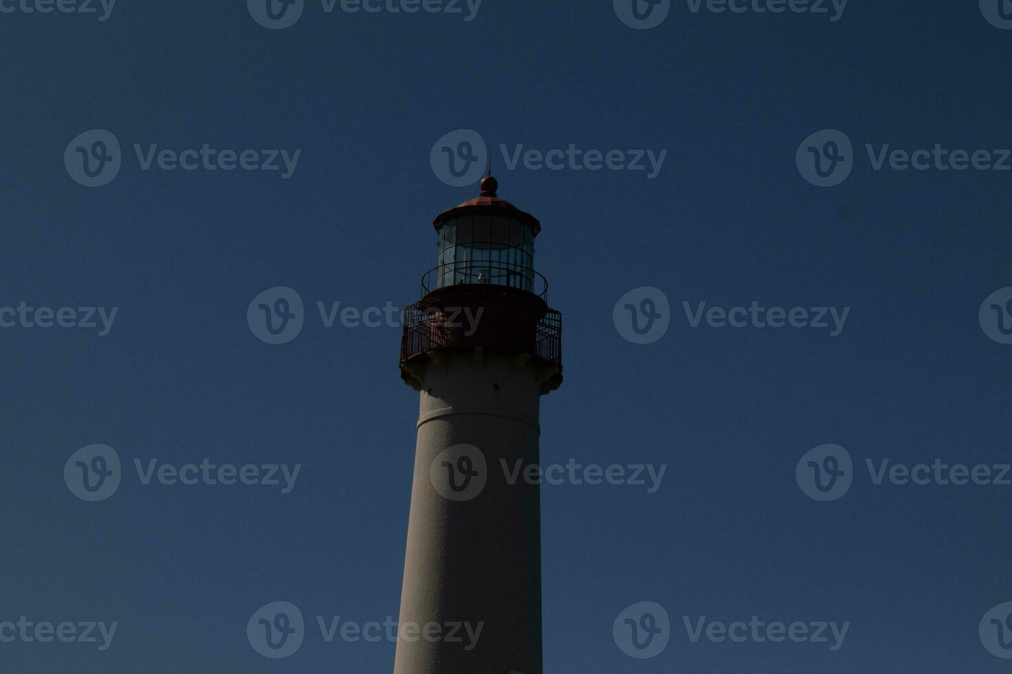 This is the top image of Capy May point lighthouse. The red metal top stands out against the white brick of the tower. photo