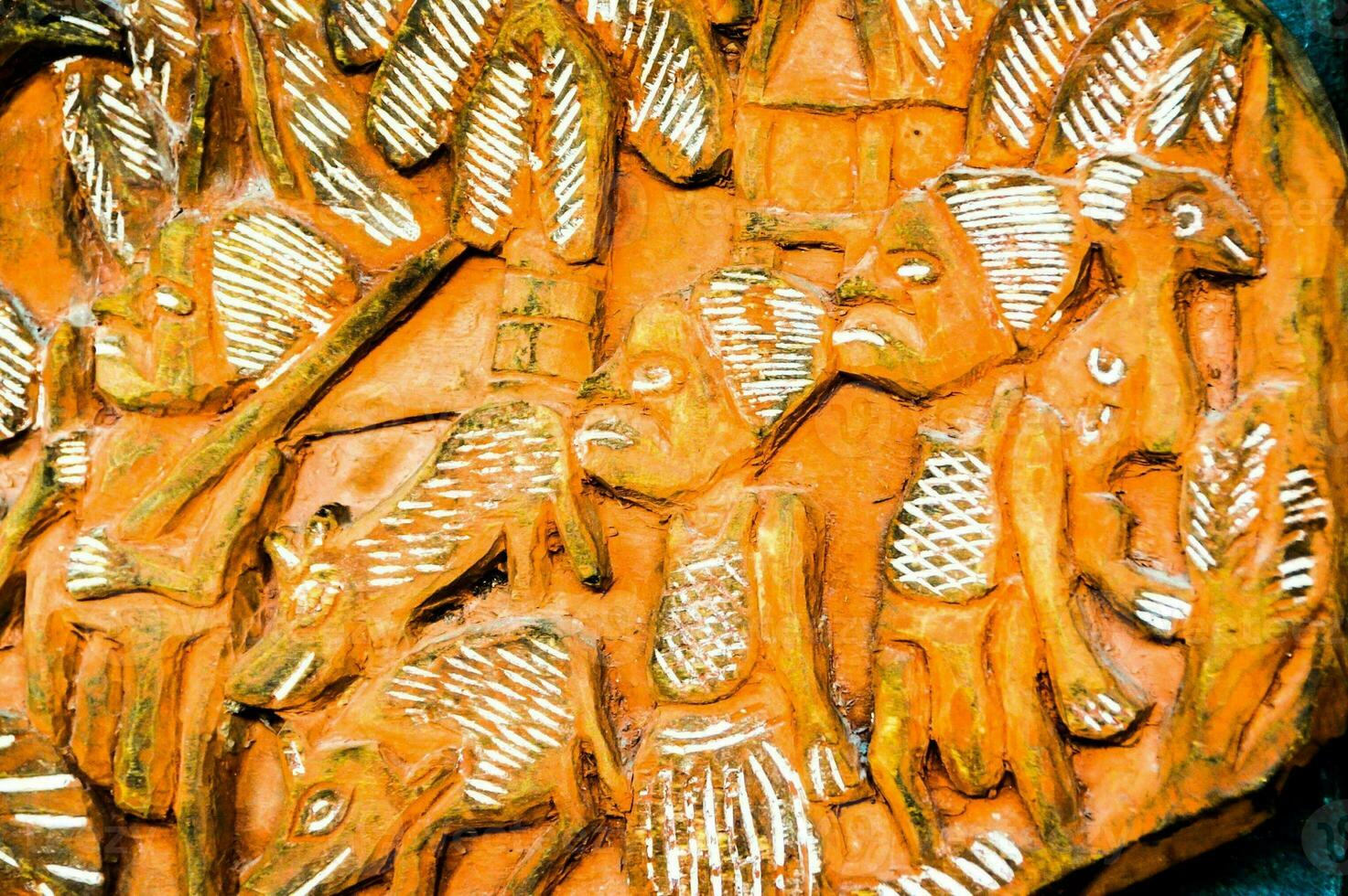 a carved wooden plaque with people and animals photo
