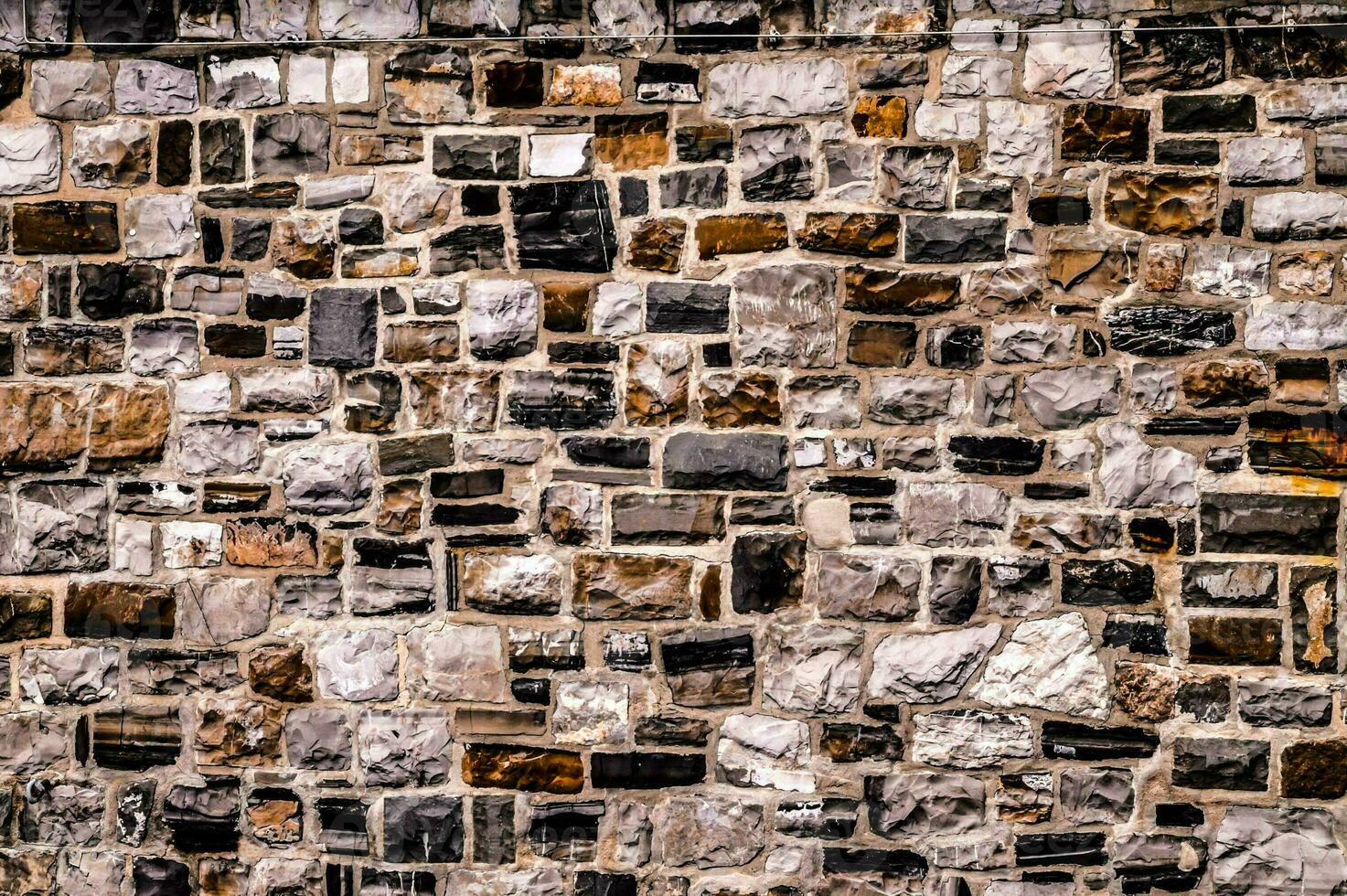 a wall made of stone with many different colors photo