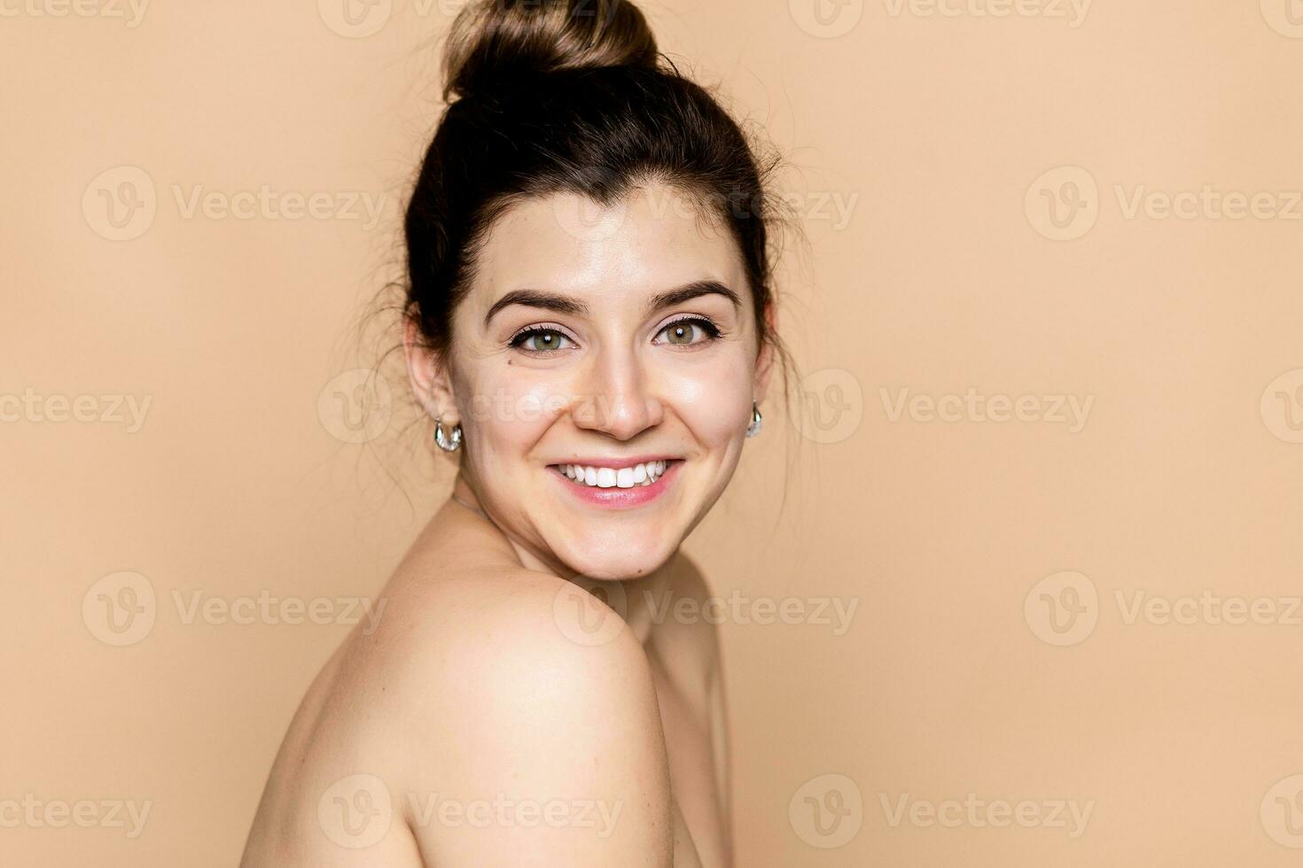 young woman face and hands over beige background photo