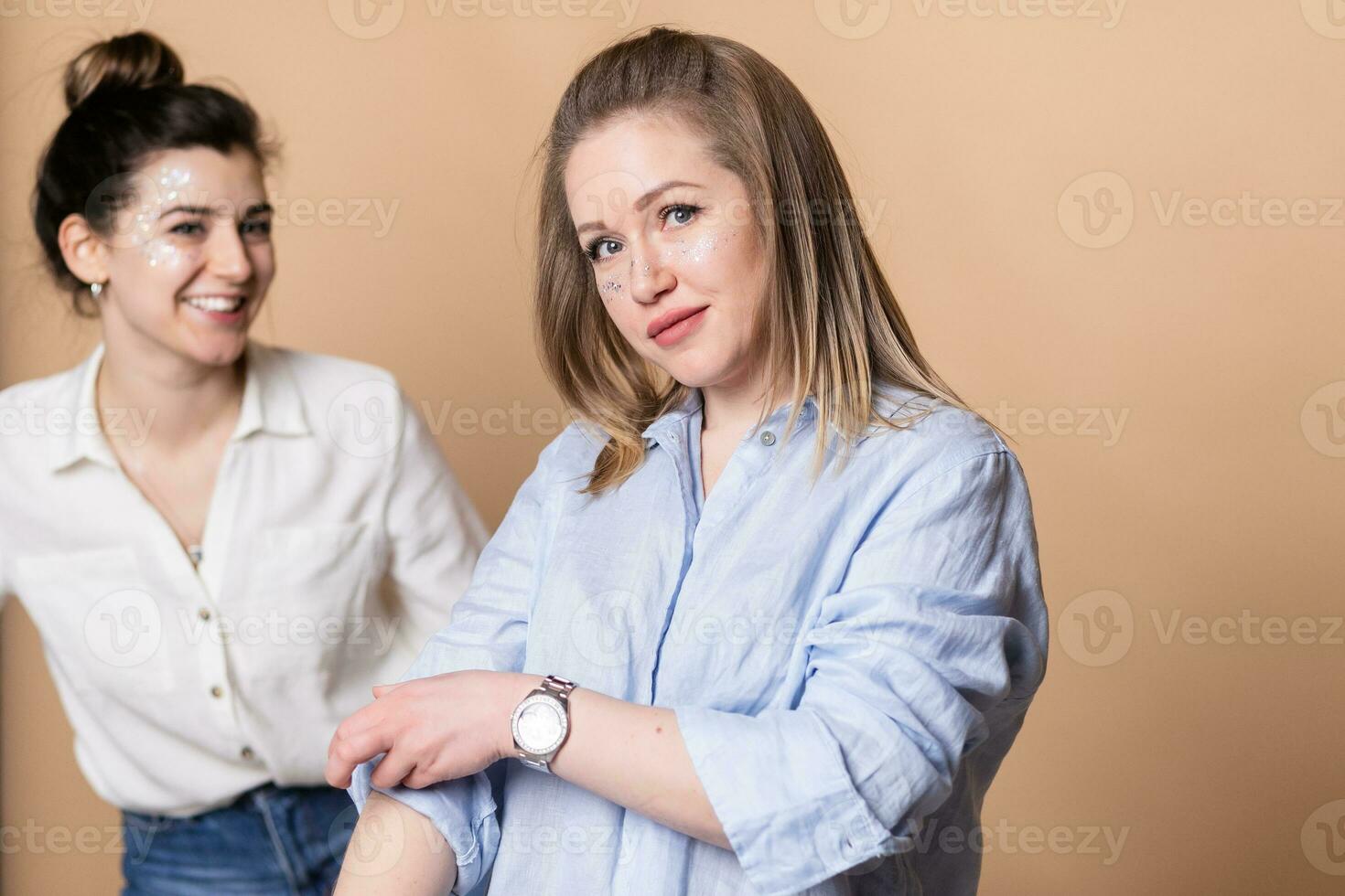 Portrait of two happy women in black and white clothes smiling photo