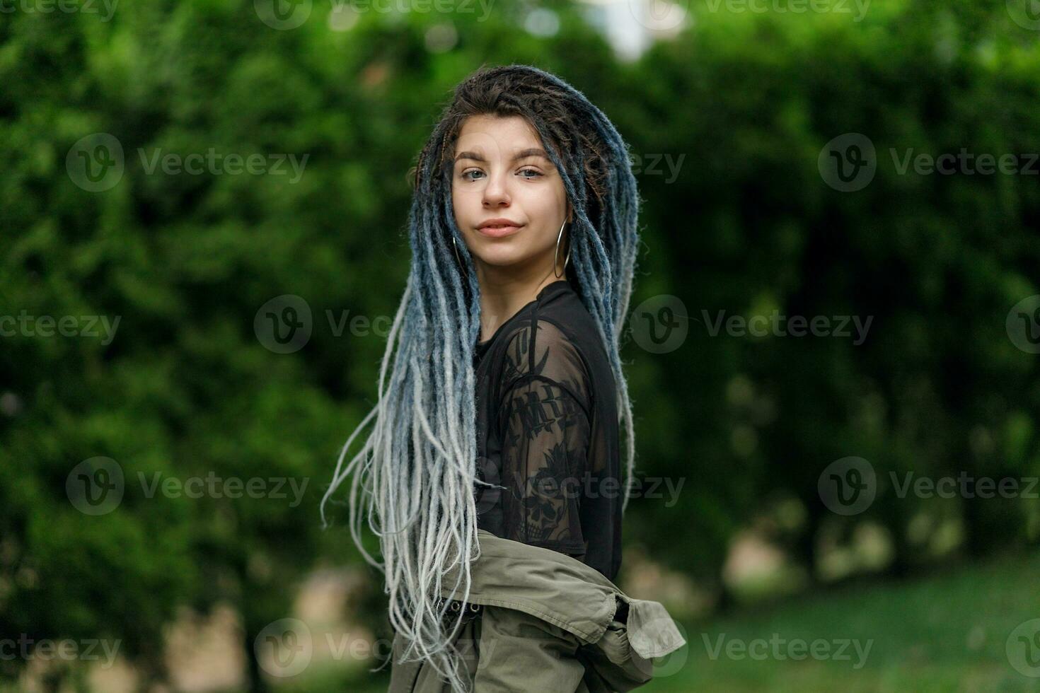 cheerful caucasian girl looking at the camera and smiling model with dreadlocks photo