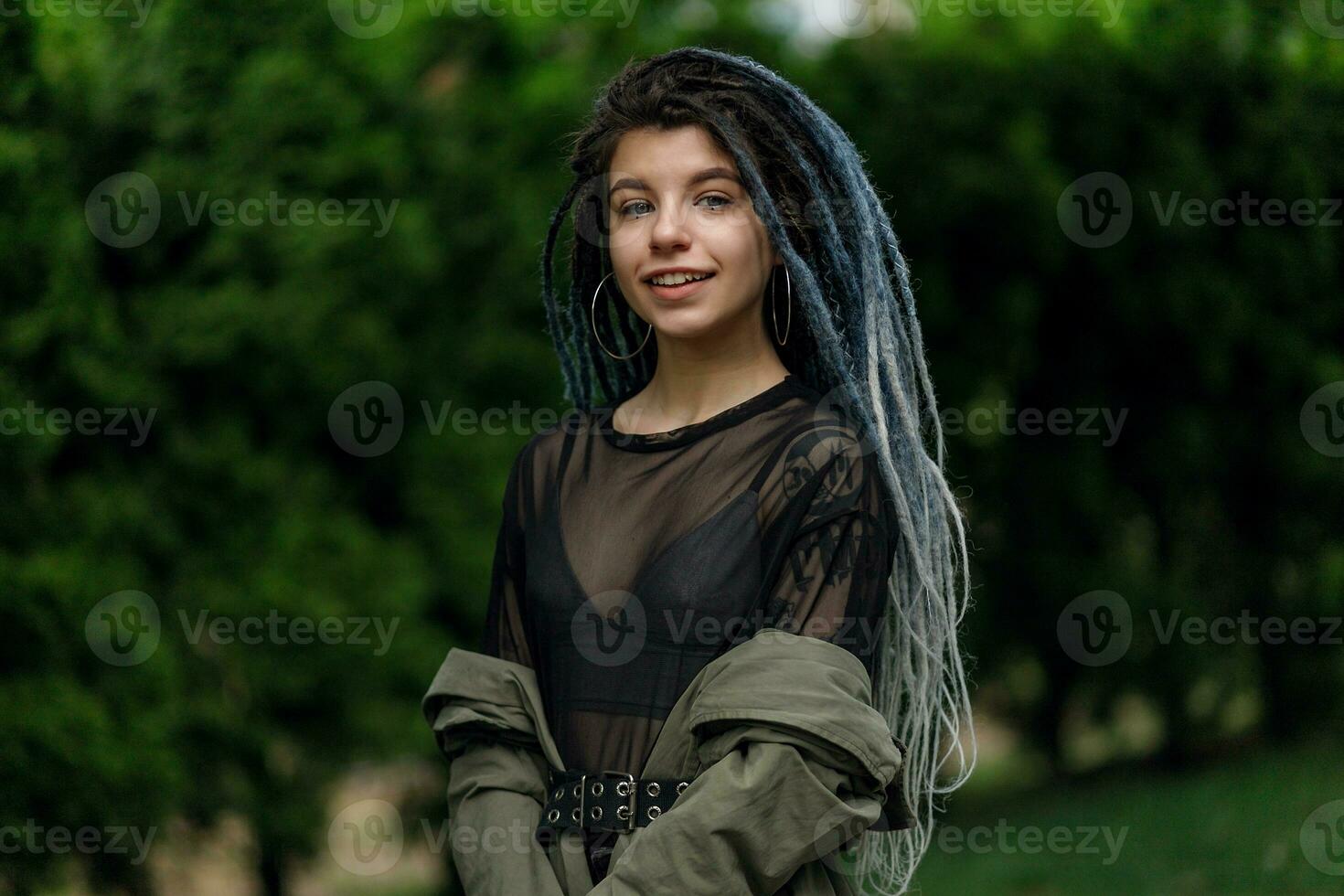 cheerful caucasian girl looking at the camera and smiling model with dreadlocks photo