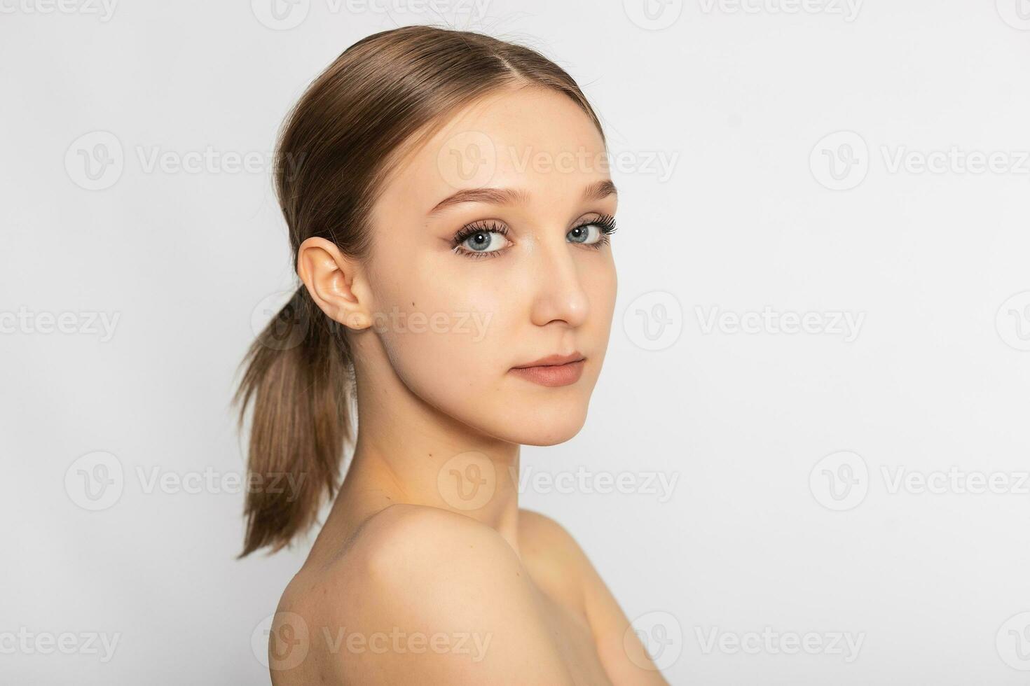 Beautiful Young Woman with Clean Fresh Skin look away . photo