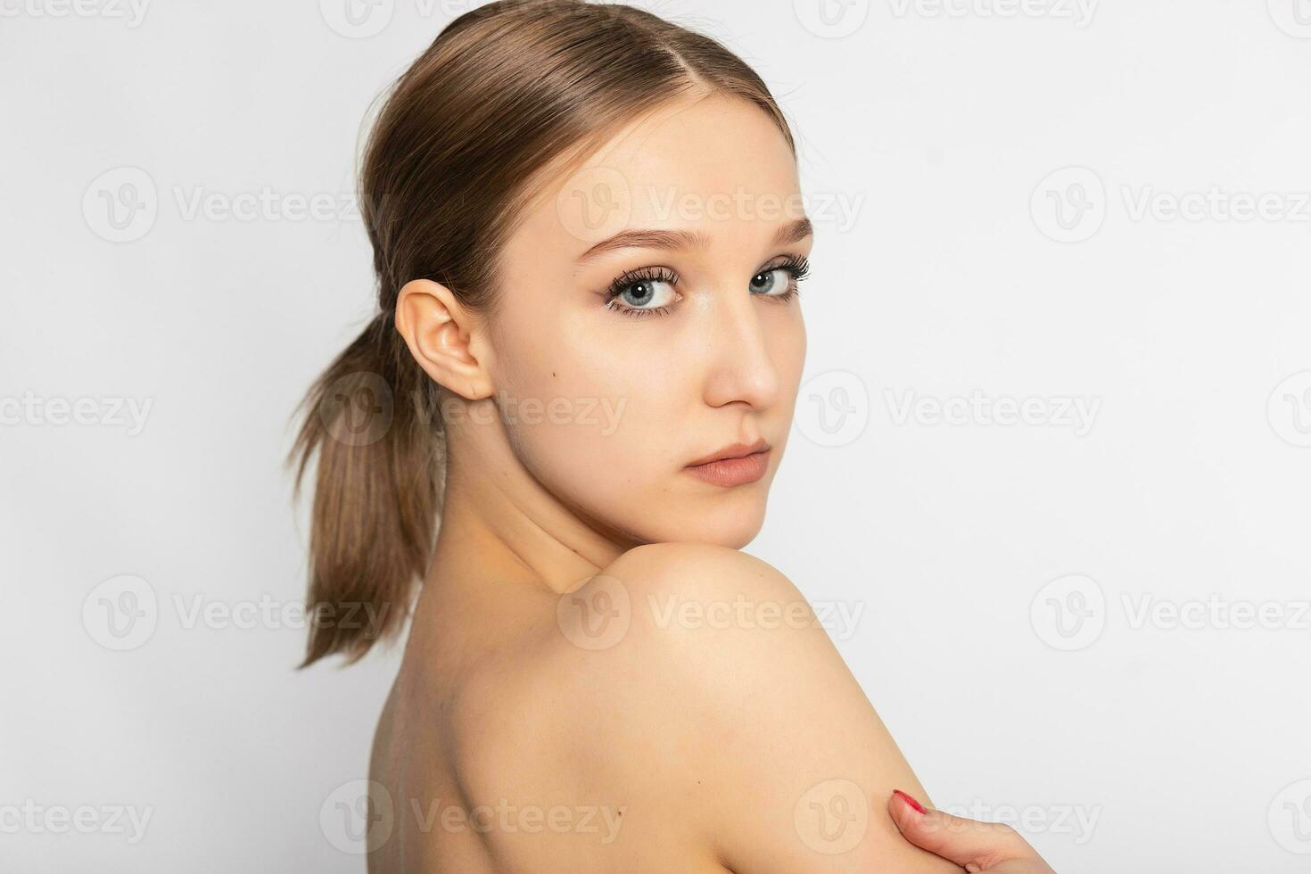 Beautiful Young Woman with Clean Fresh Skin look away . photo