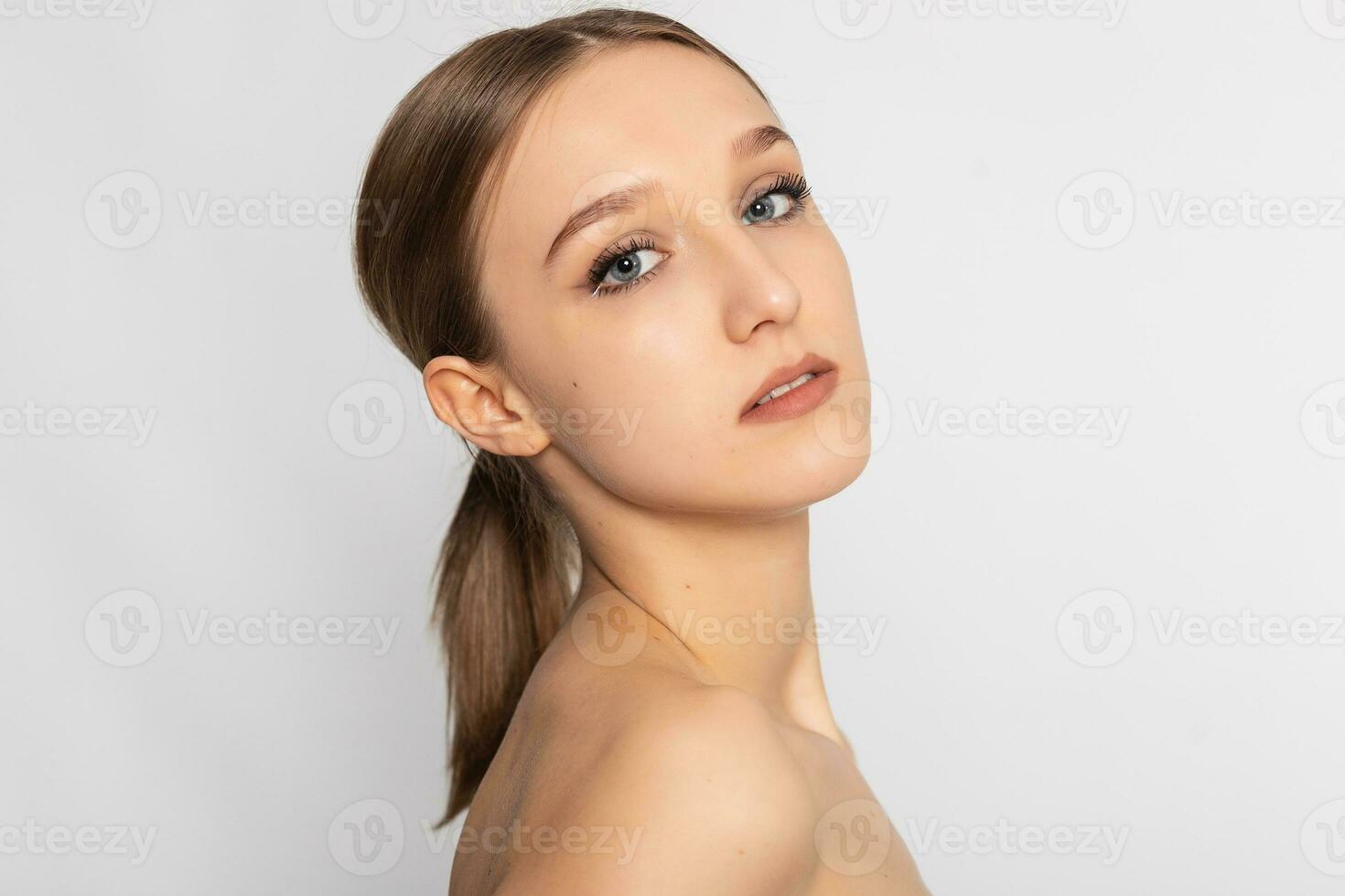 Beautiful Young Woman with Clean Fresh Skin look away . photo