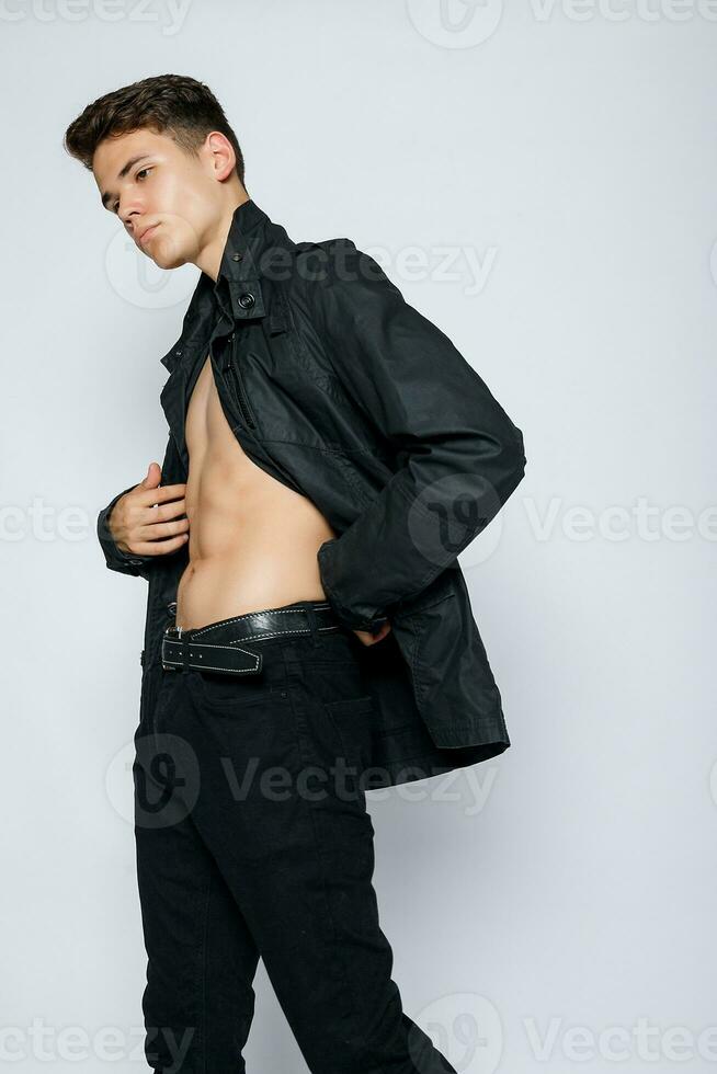 Young muscular man in a black jeans photo