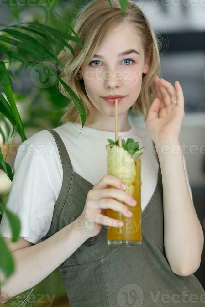 Close up young cheerful woman in dress happily looking in camera photo