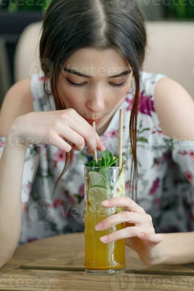 Close up young cheerful woman in dress happily looking in camera photo