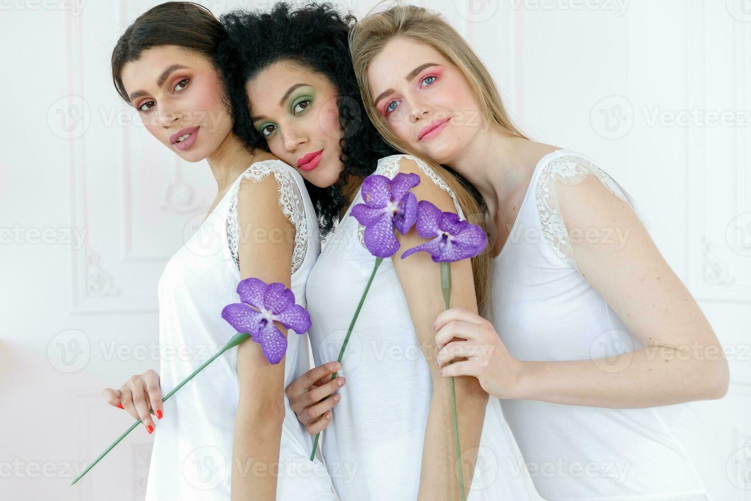 Portrait of three gorgeous multiracial young women with different types of skin photo