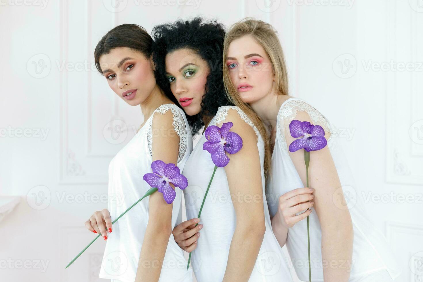 Portrait of three gorgeous multiracial young women with different types of skin photo