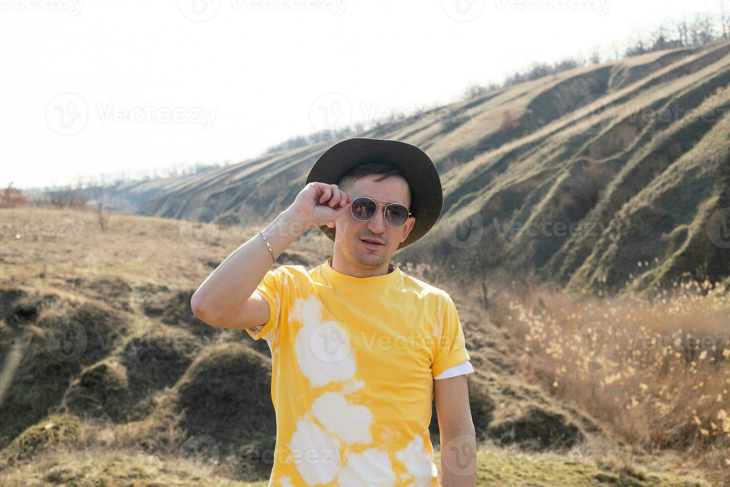 young man in spring mountains at sunset photo