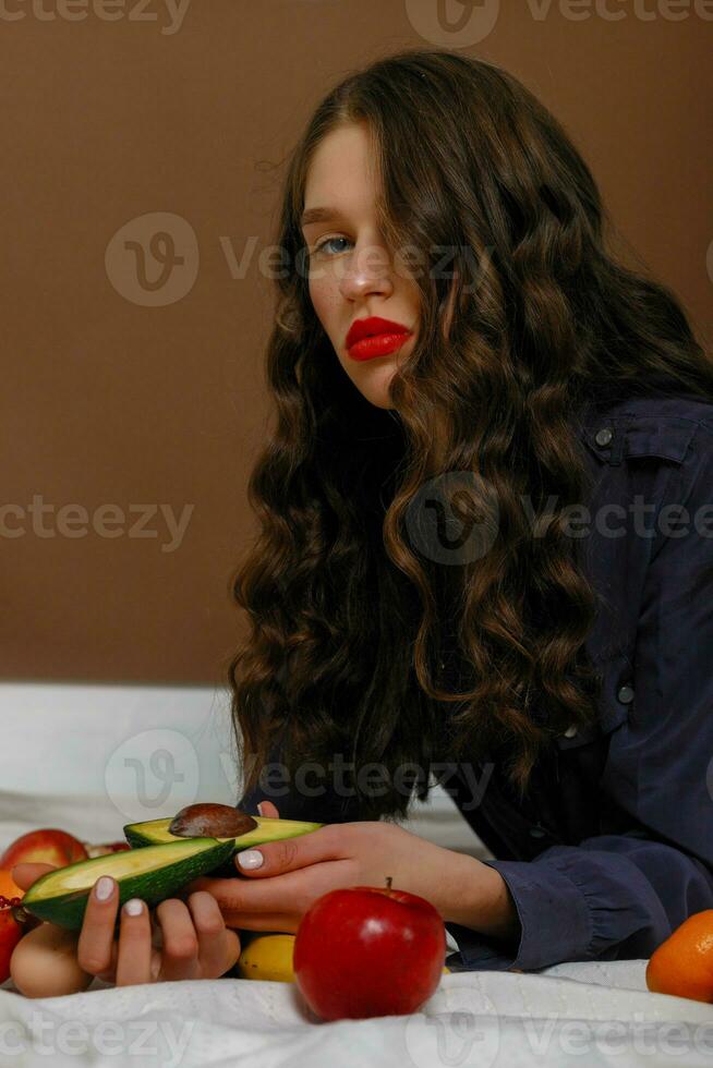 Young woman in group of fruit. Healthcare. photo