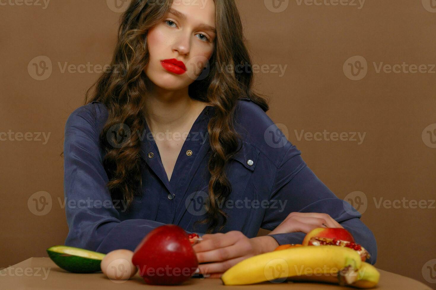 Young woman in group of fruit. Healthcare. photo