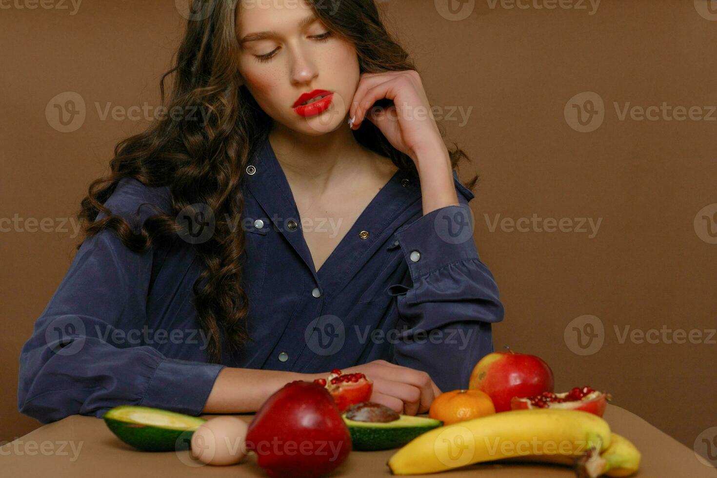 Young woman in group of fruit. Healthcare. photo