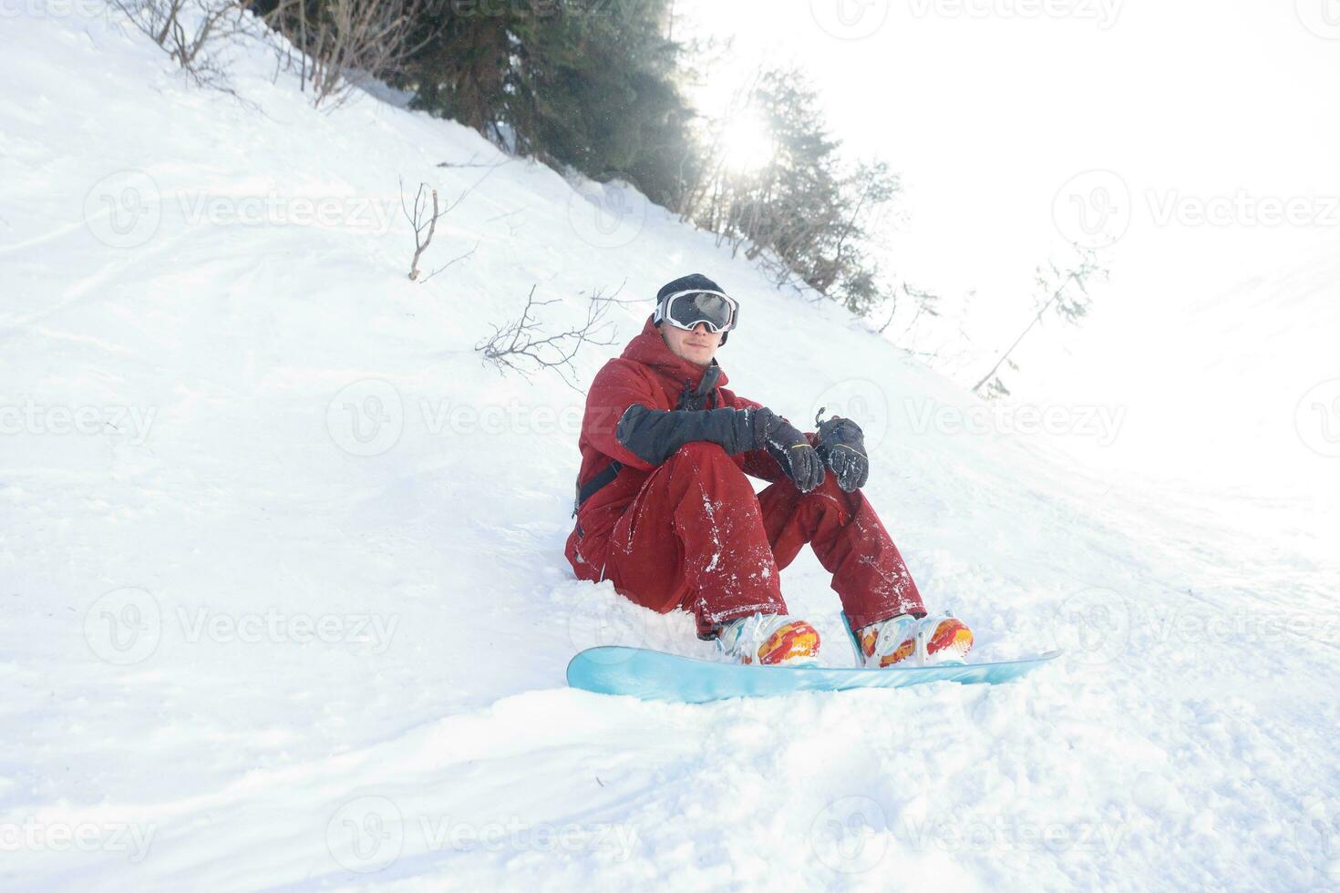 snowboarder sits high in the mountains photo