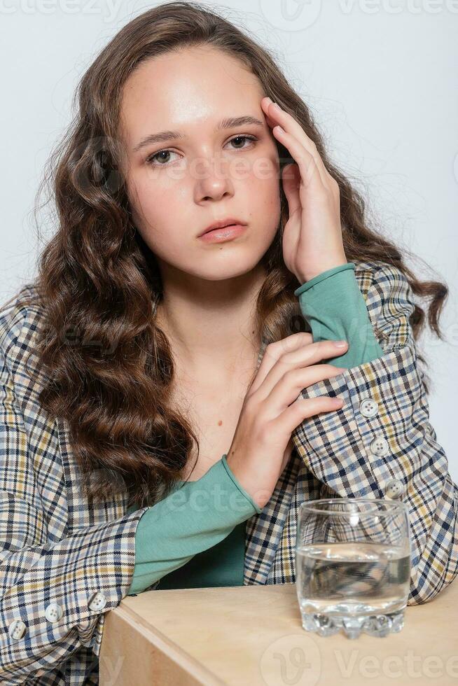 Young woman portrait with water glass. White background isolated. photo