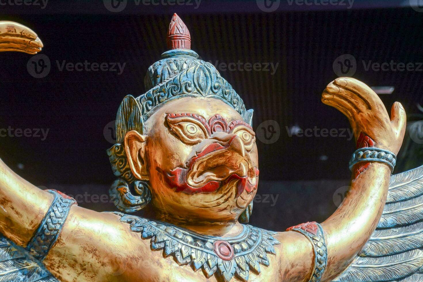 a statue of a bird with wings and a gold body photo