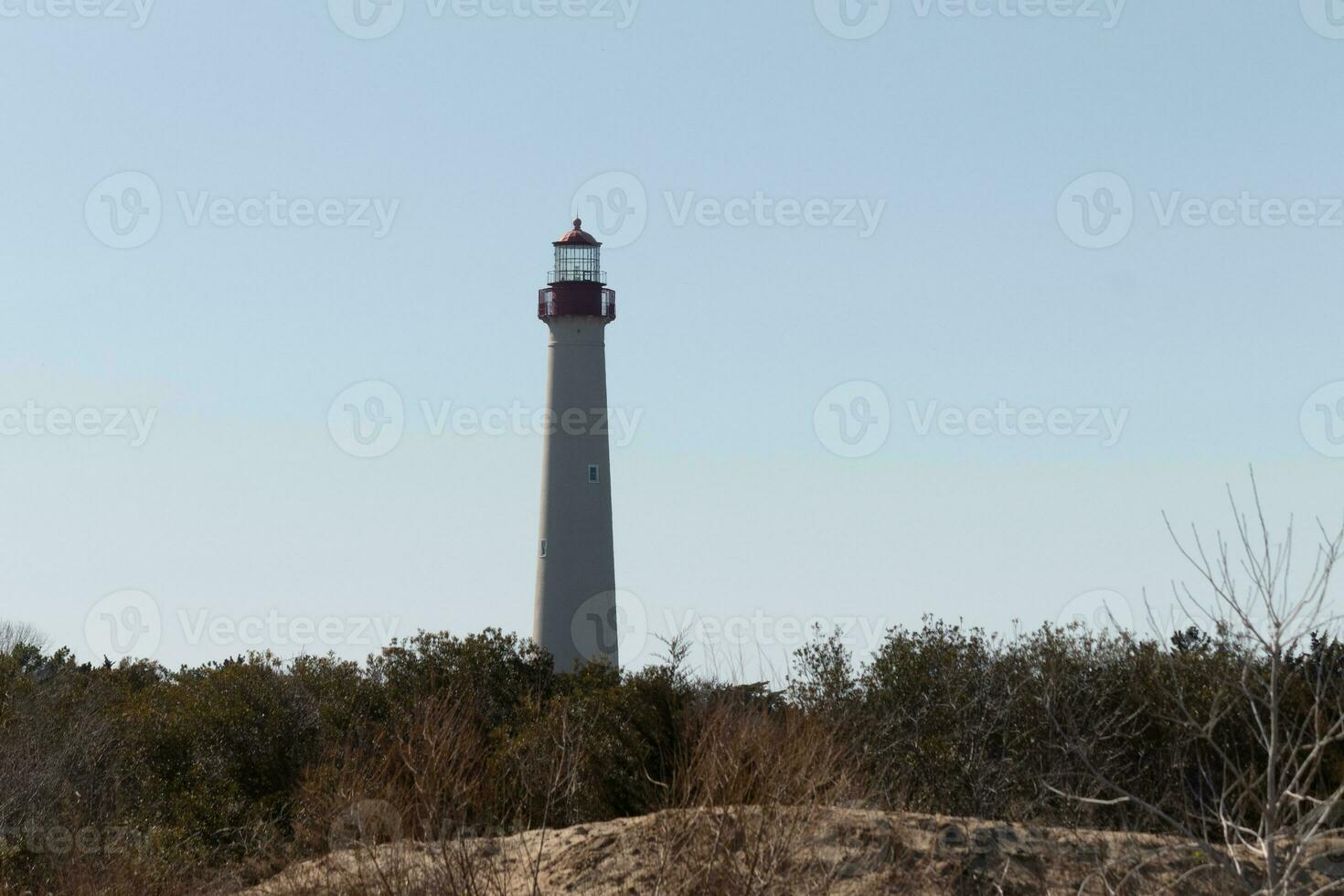 This is the Cape May point lighthouse located in the southernmost tip of New Jersey. This beacon of hope stands tall to help prevent sailors from wrecking and also letting them know where they are. photo
